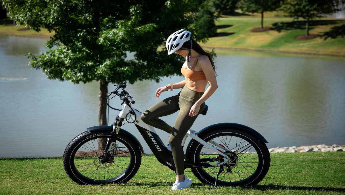 A woman riding ebike next to a lake - Best E-Bikes for Women