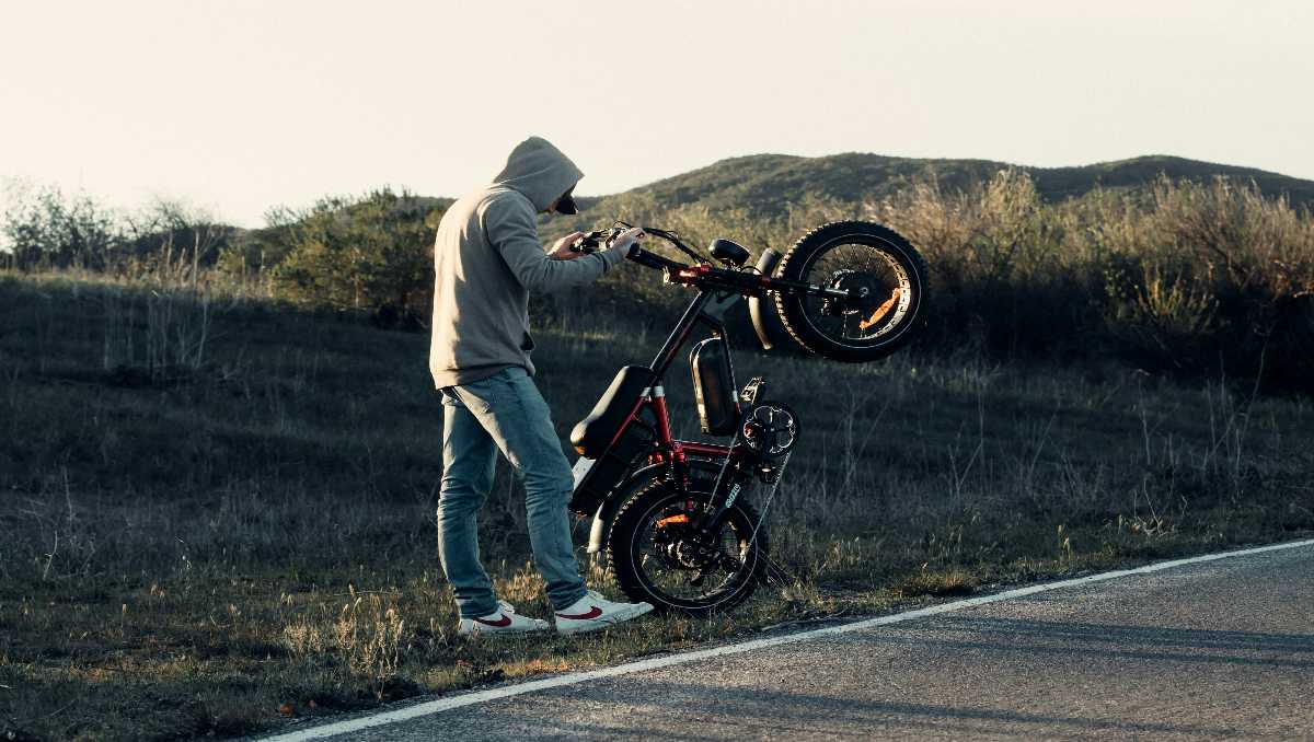 Male model riding ebike during golden hour sunset in the mountains.