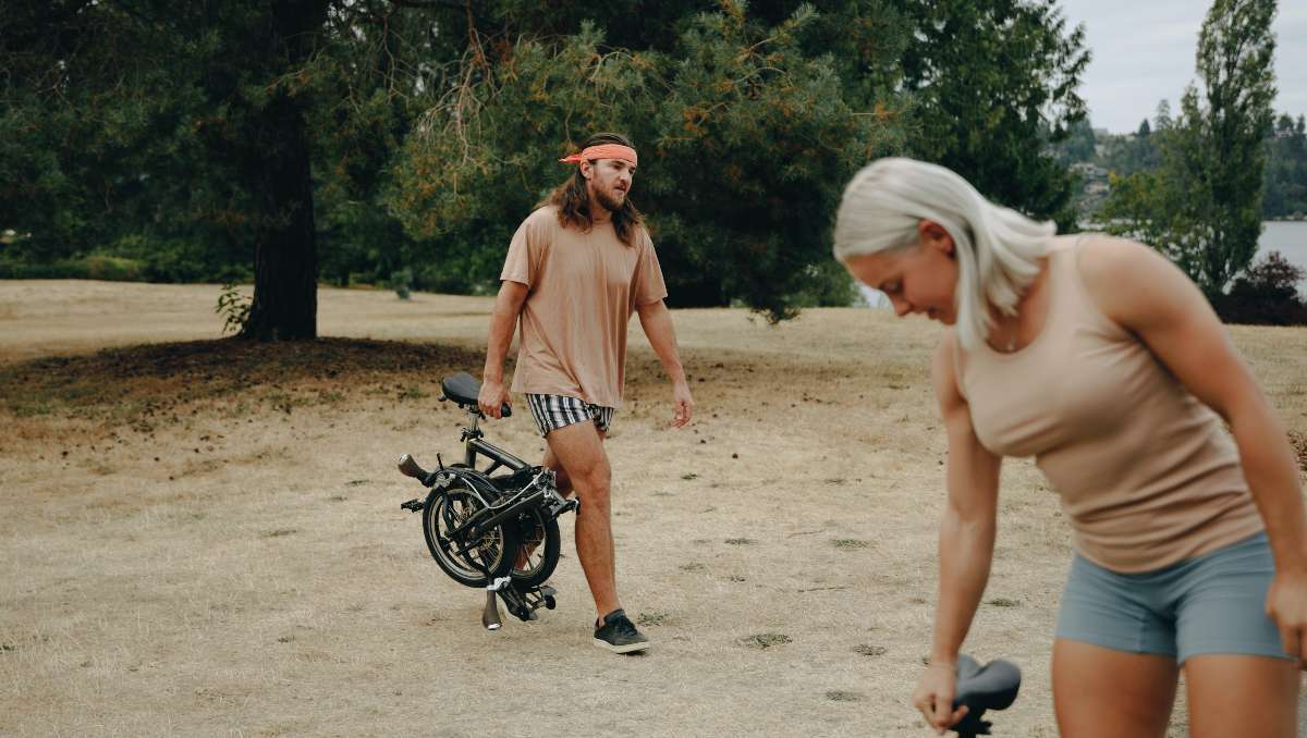 A man carrying a folding e-bike.
