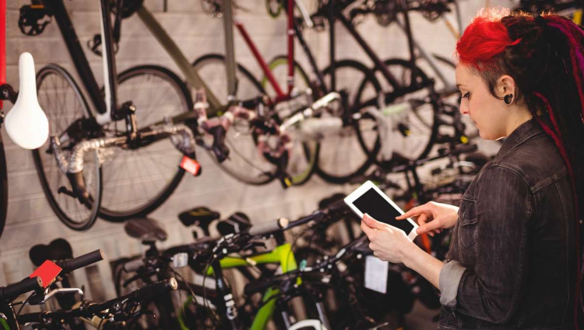 Girl buying ebikes online while the shop
