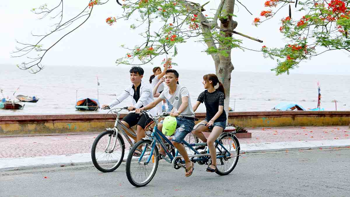 Girl and boy riding on a tandem electric bike